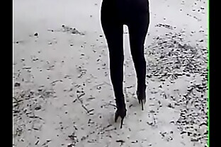 Walking on the snow with leather catsuit and ankle Platform boots. You can see my long legs and beautiful ass
