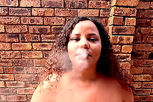 SA colored BBW chain smoking cigarettes naked outside in the garden